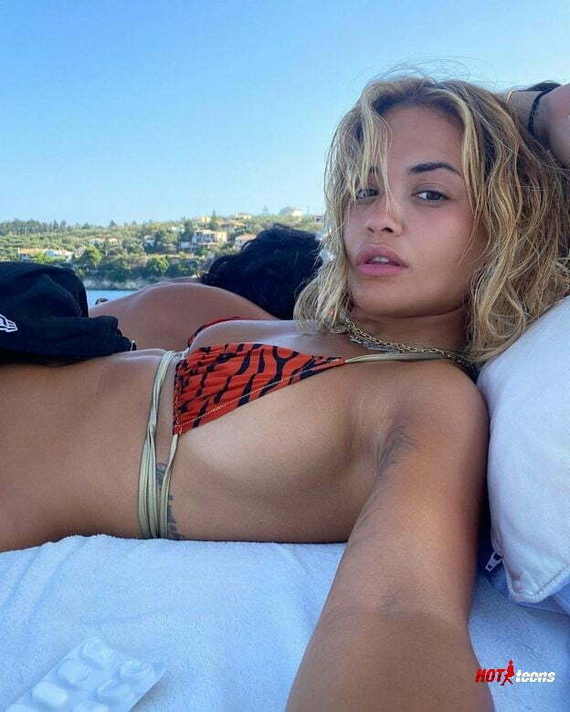 Almost naked boobs of Rita Ora covering nipples with bikini only