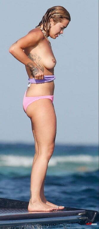 Rita Ora showing naked boobs from the side in the sea